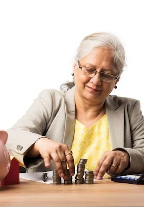 Premium Photo _ Senior Indian or asian business women saving or holding or calculating currency coins_ Business, finance and investment concept Premium Photo _ Senior Indian or asian business women saving or holding or calculating currency coins_ Business, finance and investment concept